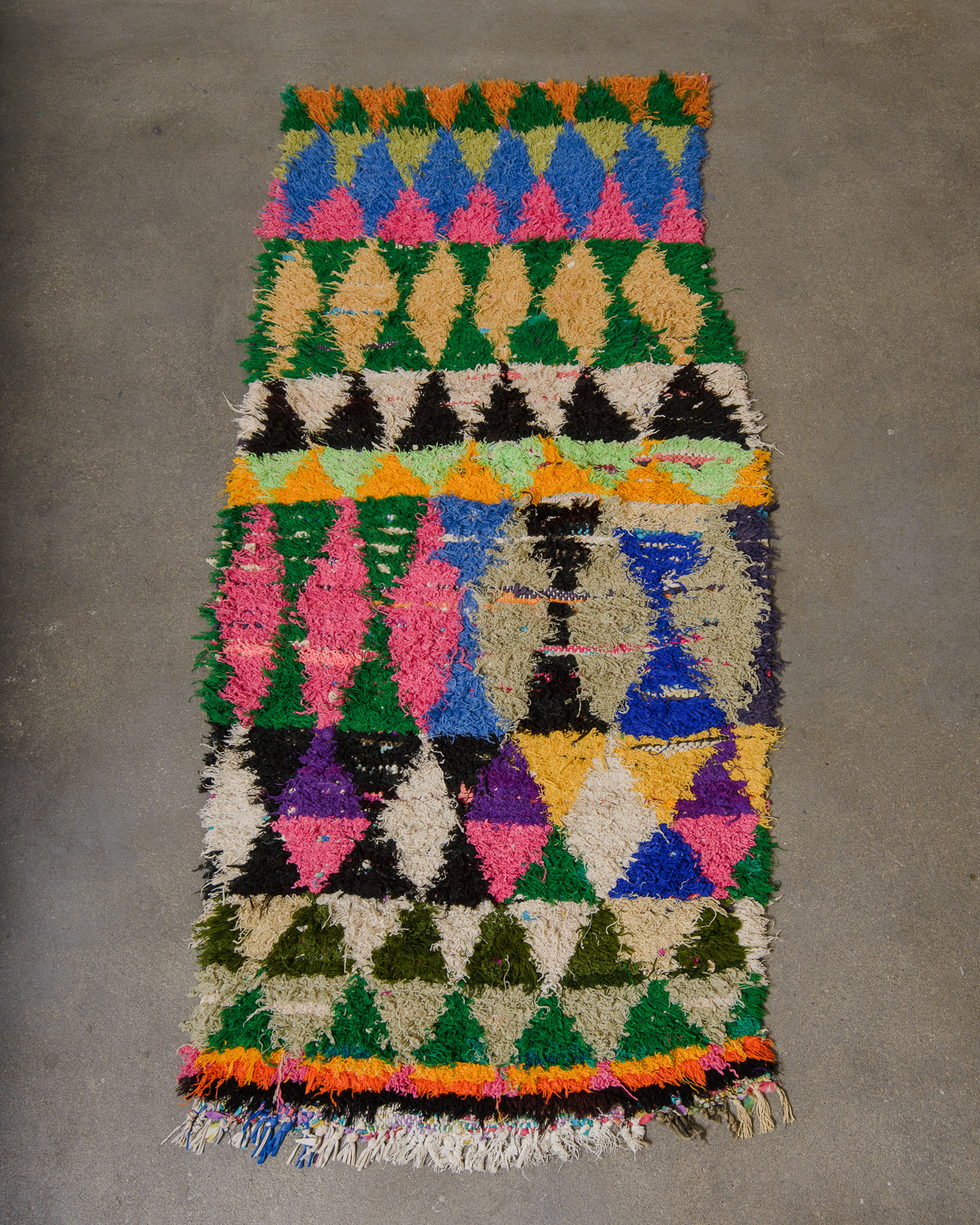 Multicolored geometric patterned rug on a gray floor